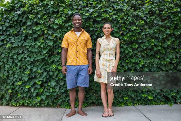 portrait of young woman and young man standing outdoors - black shorts stock pictures, royalty-free photos & images