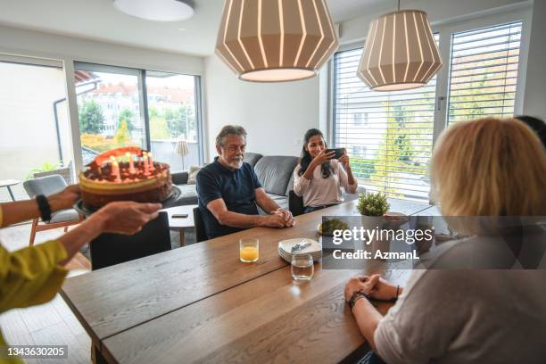 senior adult caucasian male celebrating birthday with his family - mother daughter brunch bildbanksfoton och bilder