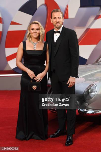 Katie Goodland and Harry Kane stand next to James Bond's Aston Martin at the World Premiere of "NO TIME TO DIE" at the Royal Albert Hall on September...