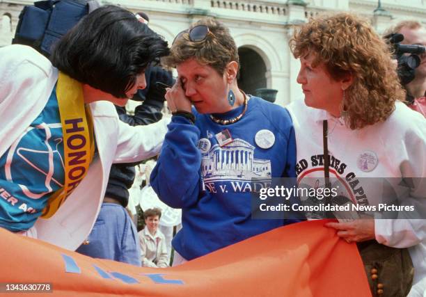 American attorney Gloria Allred comforts activist Norma McCorvey as the latter rubs her eye during the March for Women's Lives outside the US...