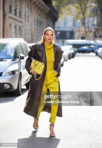 Leonie Hanne seen wearing brown coat, Bottega Veneta bag in yellow, pants, jumper, heels outside Ottolinger on September 28, 2021 in Paris, France.