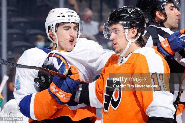 Travis Konecny of the Philadelphia Flyers holds back Cole Bardreau of the New York Islanders during a fight at Wells Fargo Center on September 28,...