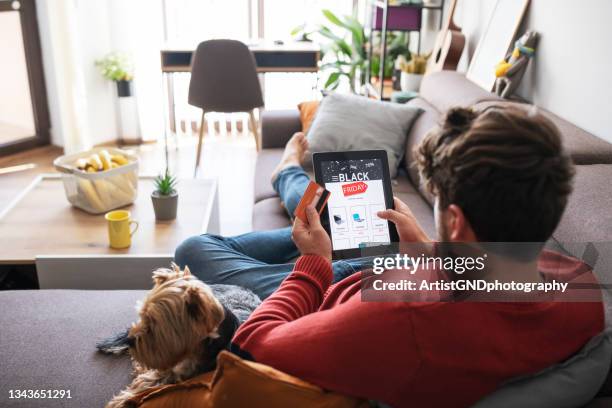 man shopping electronics online during black friday sale. - black friday shoppers stockfoto's en -beelden