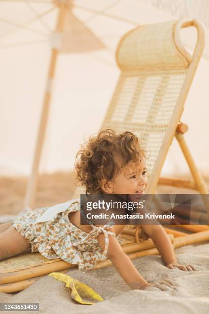 little cute baby girl is playing on a beach near a sea. - one baby girl only bildbanksfoton och bilder