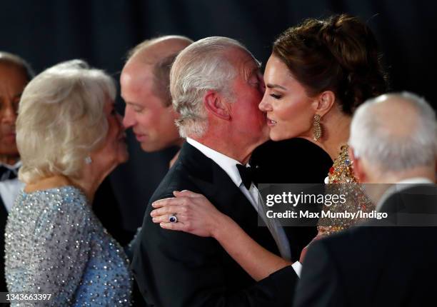 Camilla, Duchess of Cornwall kisses Prince William, Duke of Cambridge and Prince Charles, Prince of Wales kisses Catherine, Duchess of Cambridge as...