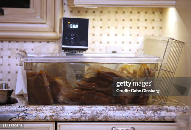 steaks cooking in a sous-vide - sous vide stock pictures, royalty-free photos & images