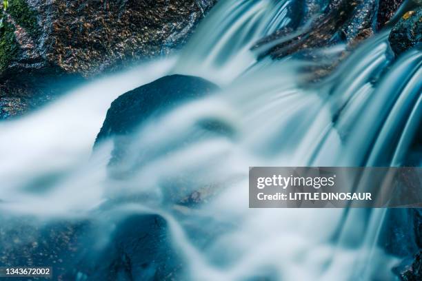 clearwater streams flowing over the rocks. long exposure - long exposure water stock pictures, royalty-free photos & images