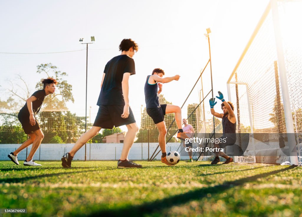 Soccer players together at field during sunny day
