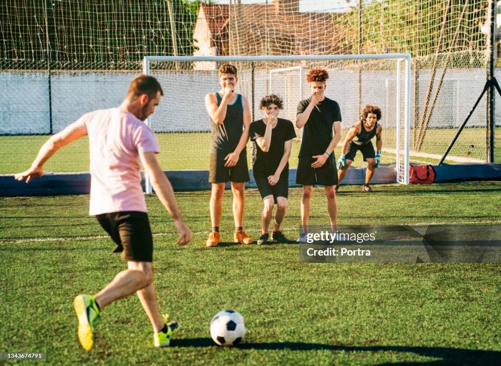 Male player kicking ball during penalty kick