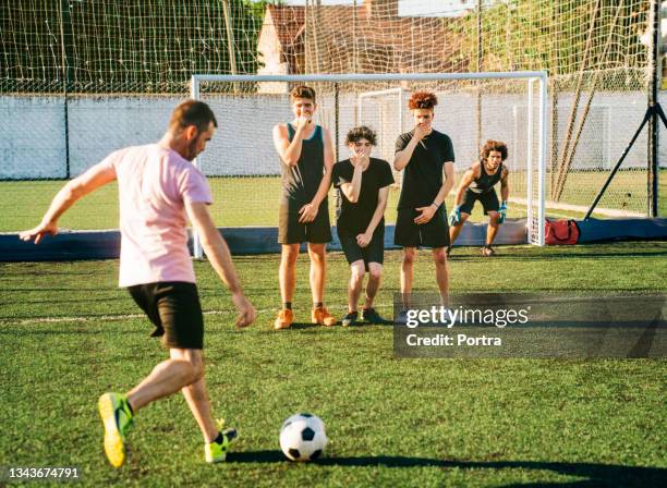 male player kicking ball during penalty kick - shooting at goal stock pictures, royalty-free photos & images