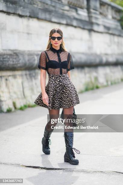 Thassia Naves wears black sunglasses, silver and pearls pendant earrings, a rhinestones J'Adior hair clip from Dior, a black bra underwear a black...