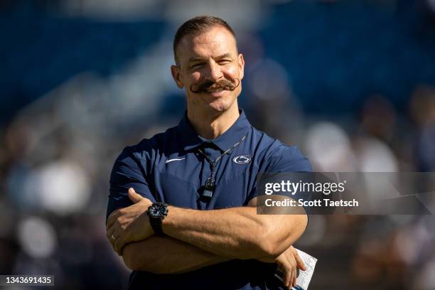 Associate director of performance enhancement Chuck Losey of the Penn State Nittany Lions looks on while sporting a handlebar mustache before the...