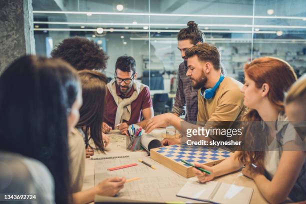 team of young freelancers working on a meeting at casual office. - employee engagement stock pictures, royalty-free photos & images