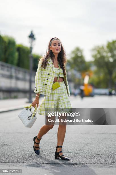 Tamara Kalinic wears gold chain pendant necklace, a pale green and white checkered print pattern blazer jacket, a matching green and white checkered...