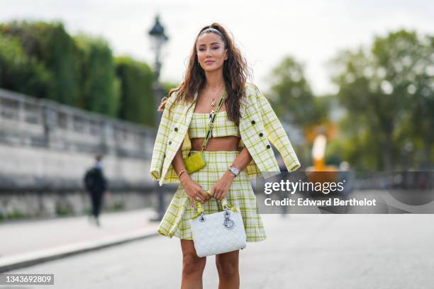 Tamara Kalinic wears gold chain pendant necklace, a pale green and white checkered print pattern blazer jacket, a matching green and white checkered...