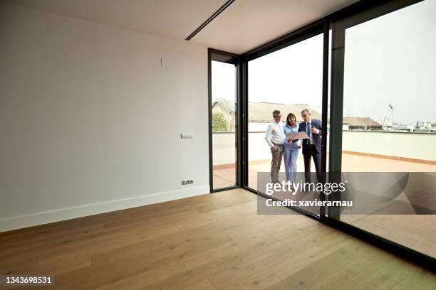 real estate agent showing floor plan to prospective buyers - house viewing stock pictures, royalty-free photos & images