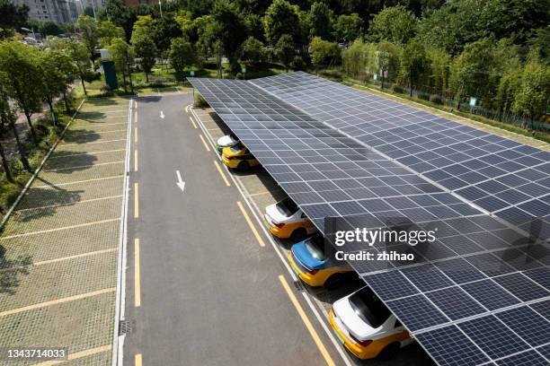 solar panel roof of electric vehicle charging station - parking space stock pictures, royalty-free photos & images