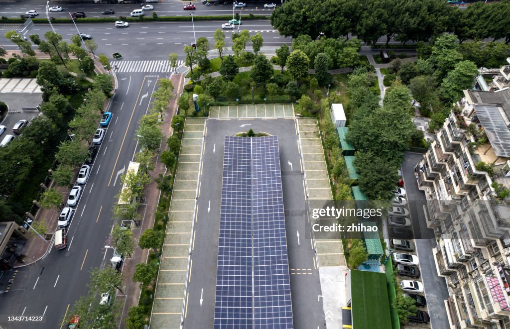 Looking down on a community parking lot with solar panels on the roof