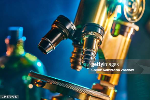 old antique microscope closeup. - boiling flask stock pictures, royalty-free photos & images