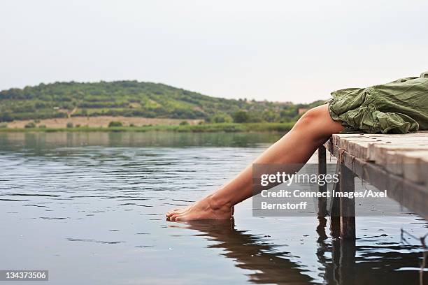 woman dipping toes into lake - viewpoint balaton stock pictures, royalty-free photos & images