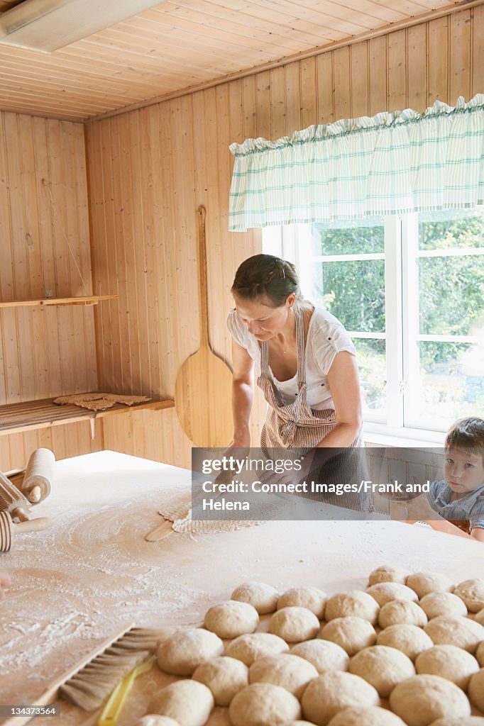 Woman rolling out dough on counter