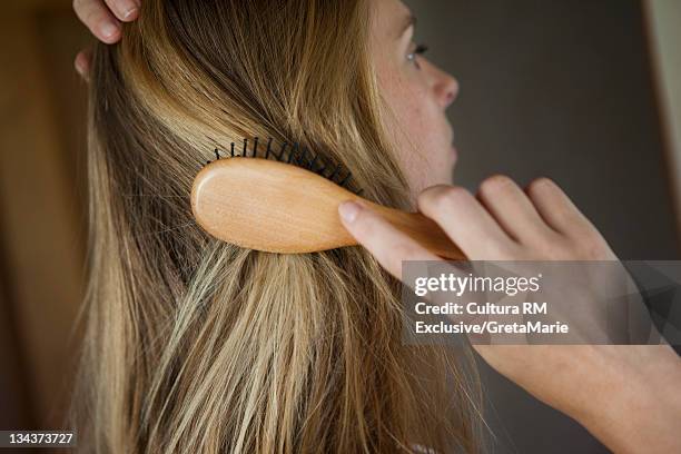 close up of woman brushing her hair - human hair bildbanksfoton och bilder