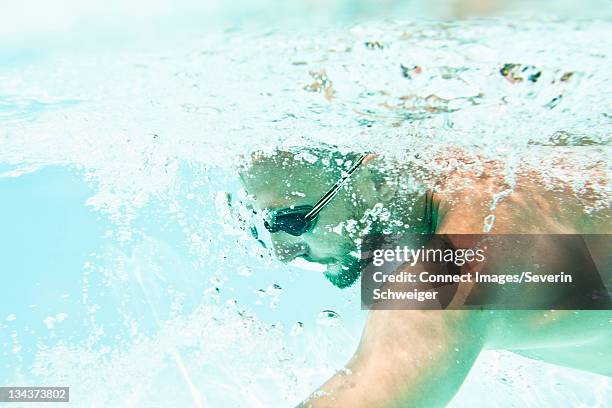 man in goggles swimming in pool - algarve underwater stock pictures, royalty-free photos & images