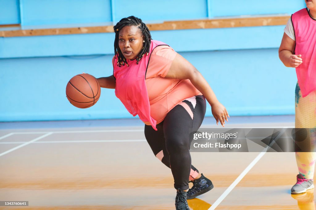 Woman playing basketball