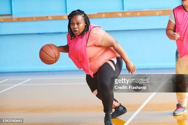 woman playing basketball - fitness or vitality or sport and women stock pictures, royalty-free photos & images