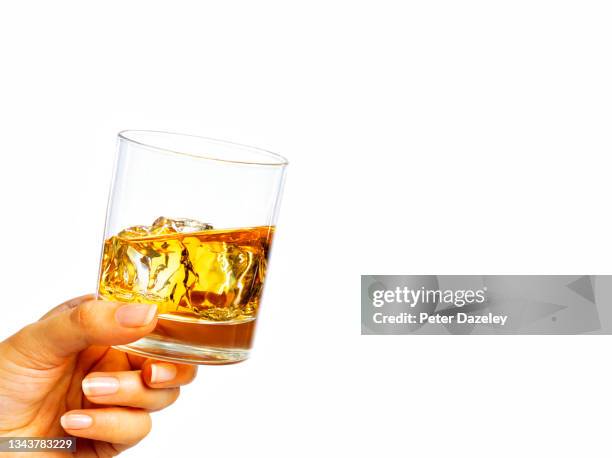 woman holding whisky glass - hand holding whiskey glass stock pictures, royalty-free photos & images