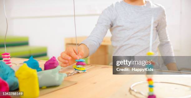 boy making spine model out of plasticine - gray shirt mockup stock pictures, royalty-free photos & images