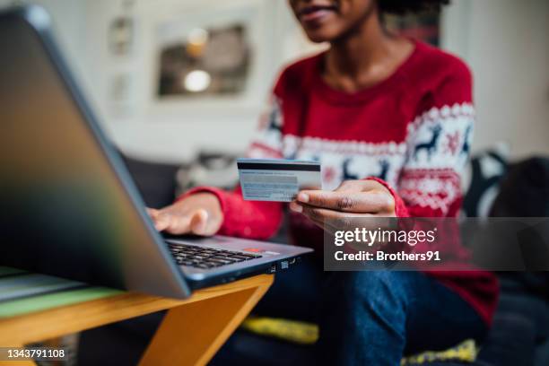 close up of an unrecognizable african american woman spending winter holidays at home - online shopping bildbanksfoton och bilder