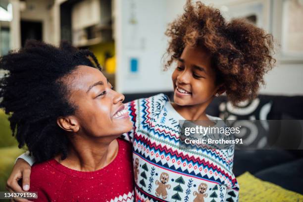 happy african american mother spending winter holidays at home with her daughter - happy holidays family stock pictures, royalty-free photos & images