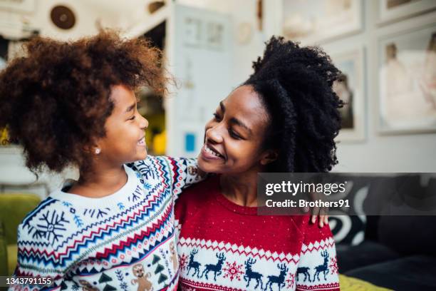happy african american mother spending winter holidays at home with her daughter - happy holidays family stock pictures, royalty-free photos & images