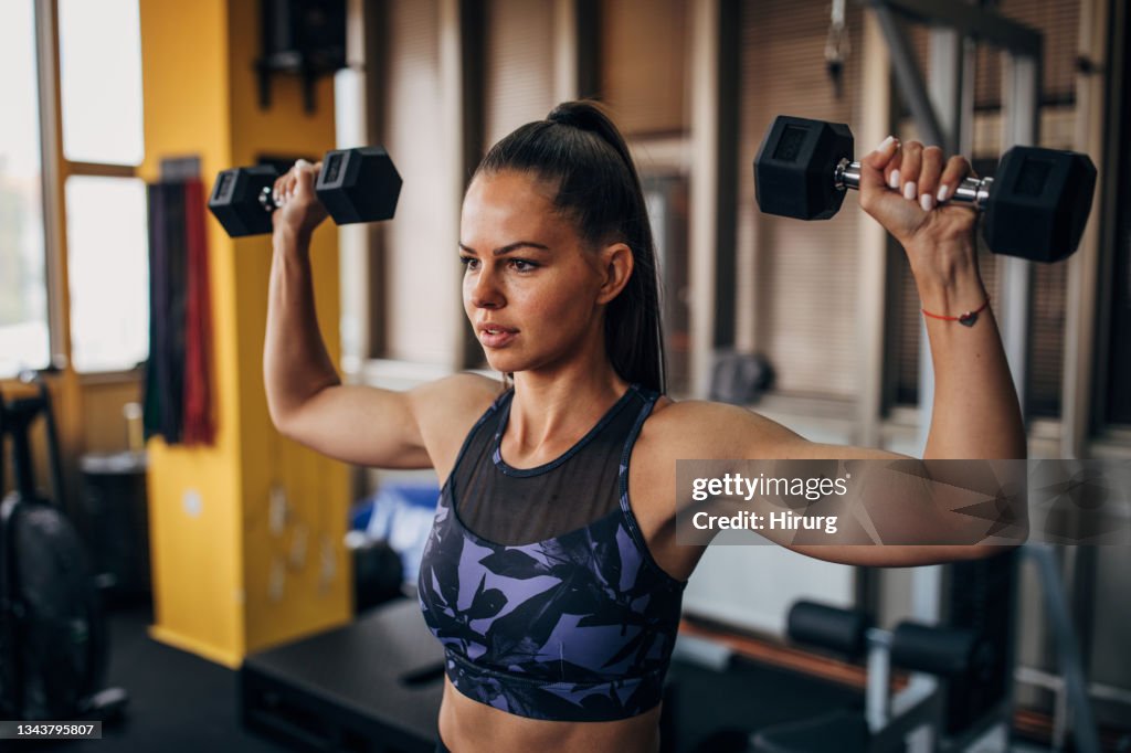 Female training with dumbbells