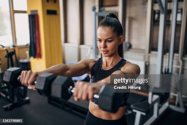 female training with dumbbells - women's weightlifting stock pictures, royalty-free photos & images