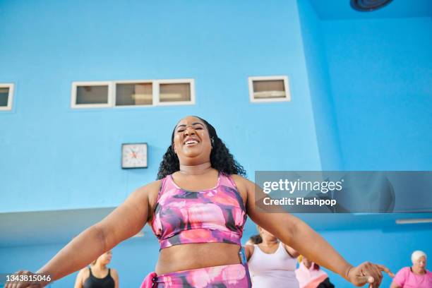 woman stretching her arms and torso. - woman arms outstretched stock pictures, royalty-free photos & images