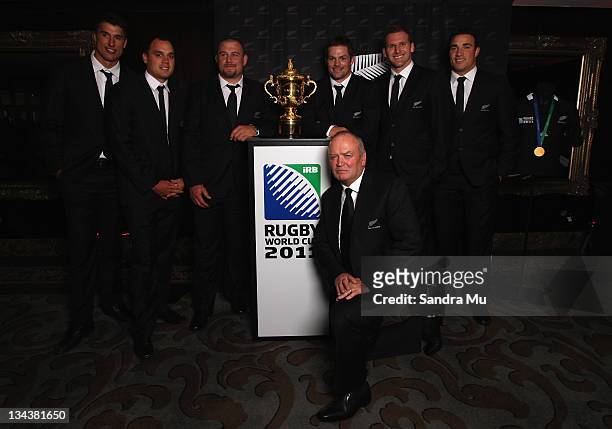 All Blacks Anthony Boric, Israel Dagg, Tony Woodcock, Graham Henry, Richie McCaw, Kieran Read and Richard Kahui pose with the Rugby World Cup during...