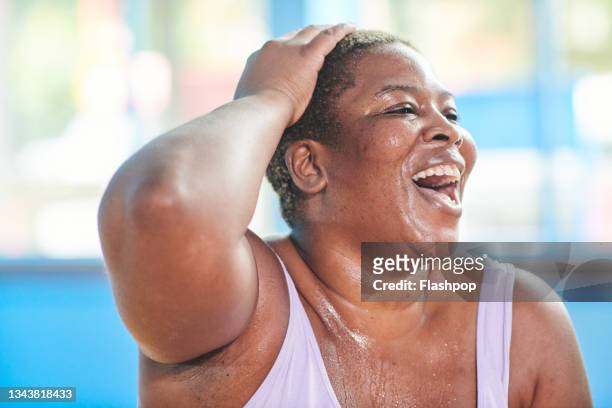 close-up portrait of a woman at the gym laughing. - sudor fotografías e imágenes de stock