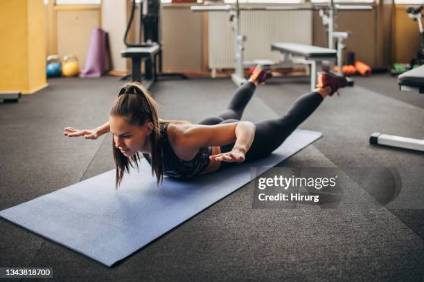 fit woman exercising in gym - lying on front stock pictures, royalty-free photos & images