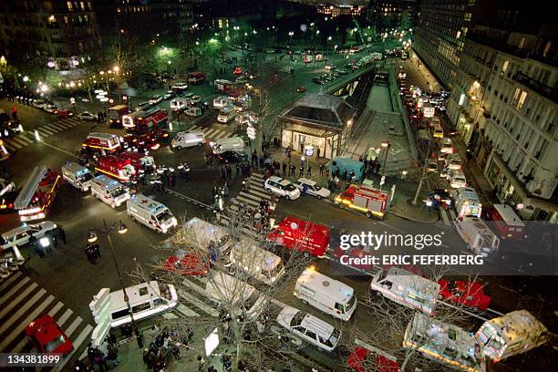 Policemen and firemen stand in front of the Port-Royal commuter train-station in Paris on December 03, 1996 after a bomb blast in a commuter train...