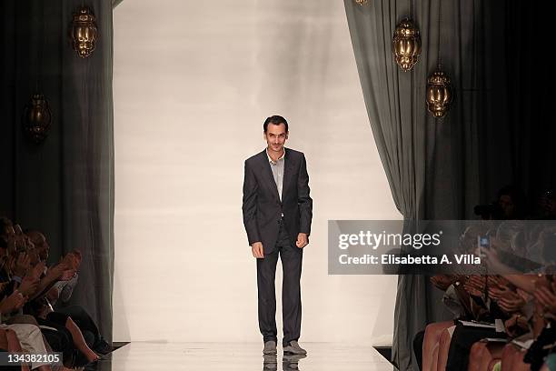 Designer Rami Al Ali is applauded as he walks the runway during his fashion show as part of AltaRoma AltaModa Autumn/Winter 2010 on July 12, 2010 in...