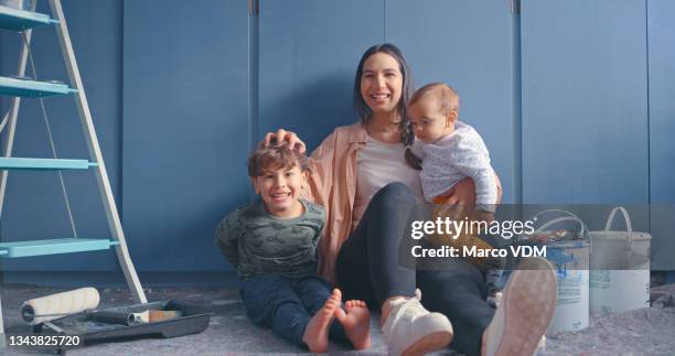 shot of a woman sitting with her two sons in a room undergoing renovations - diy painting stock pictures, royalty-free photos & images