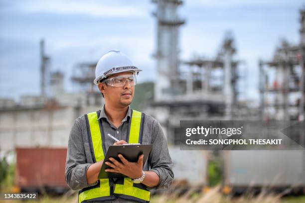 refinery engineers taking system data after system audit - oil rig engineers stock pictures, royalty-free photos & images