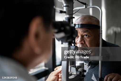 Ophthalmologist examining patient's eyes Ophthalmologist examining patient's eyes