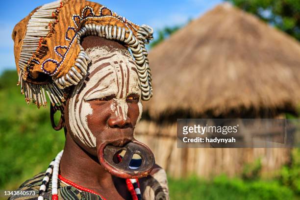 portrait of woman from mursi tribe, ethiopia, africa - african tribal images stock pictures, royalty-free photos & images