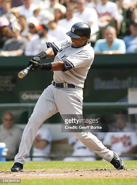 Yankees center fielder Bernie Williams makes contact with a pitch from Orioles pitcher Hayden Penn at Camden Yards, in Baltimore, Maryland on...