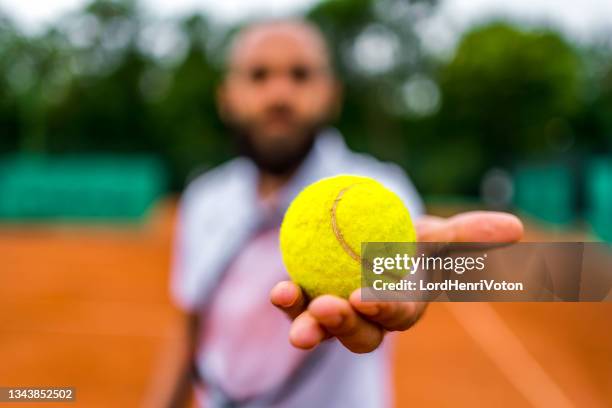 tennis player holding the ball - tennis ball hand stock pictures, royalty-free photos & images