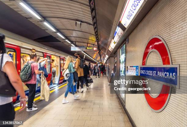 london underground passengers at king's cross st. pancras station - crowded underground london stock pictures, royalty-free photos & images