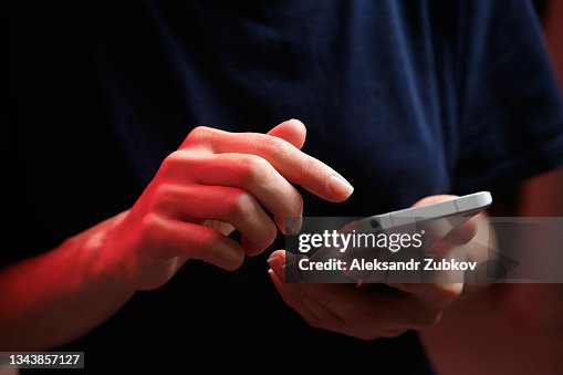 A mobile phone in the hands of a girl. A young woman in a black T-shirt is holding a phone. The fraudster sends an email message. The work of a freelancer, businessman. The wife checks messages and notifications on social networks. Wireless technologies. A mobile phone in the hands of a girl. A young woman in a black T-shirt is holding a phone. The fraudster sends an email message. The work of a freelancer, businessman. The wife checks messages and notifications on social networks. Wireless technologies.